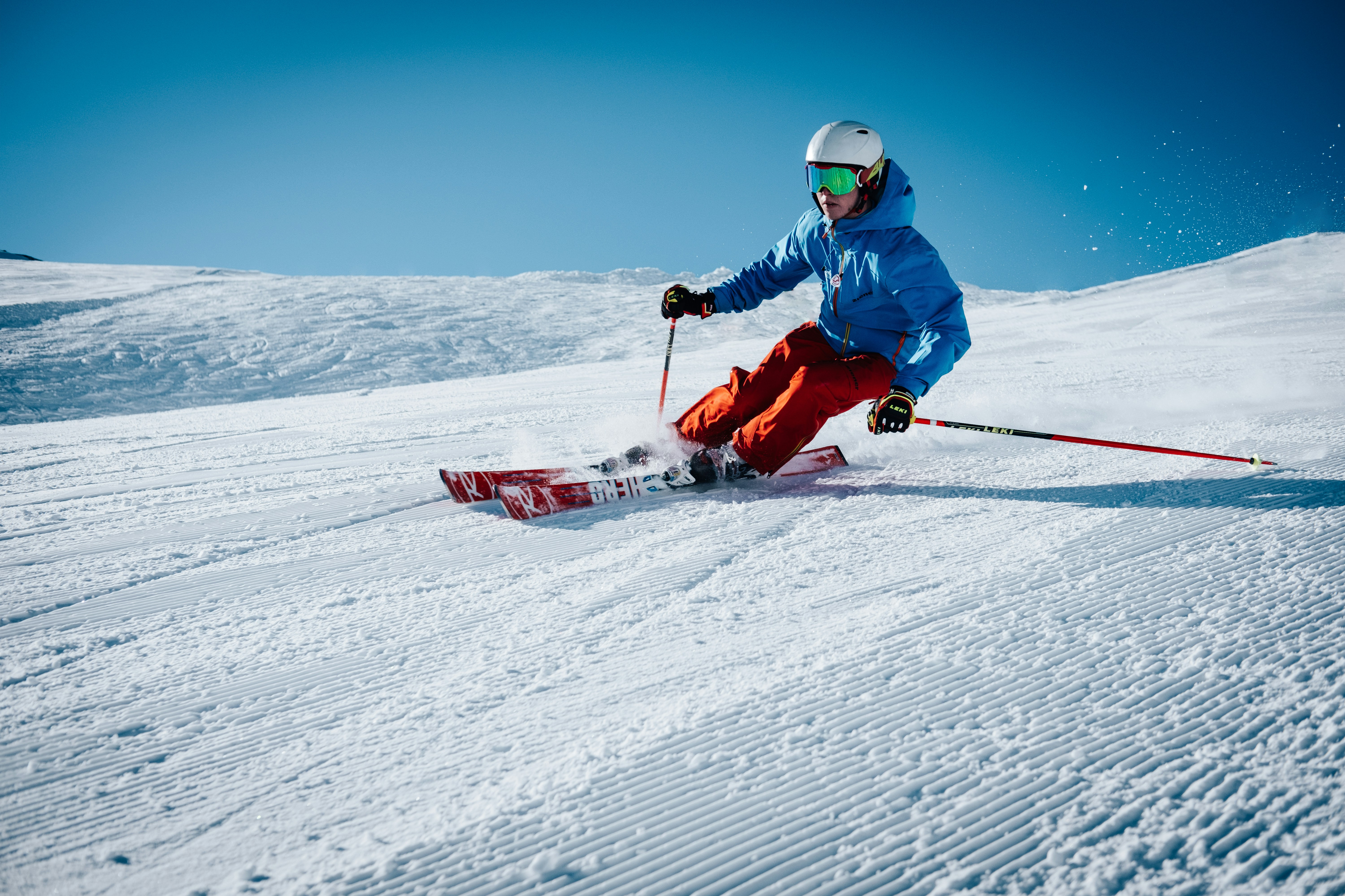Skier descending a snow-covered mountain slope