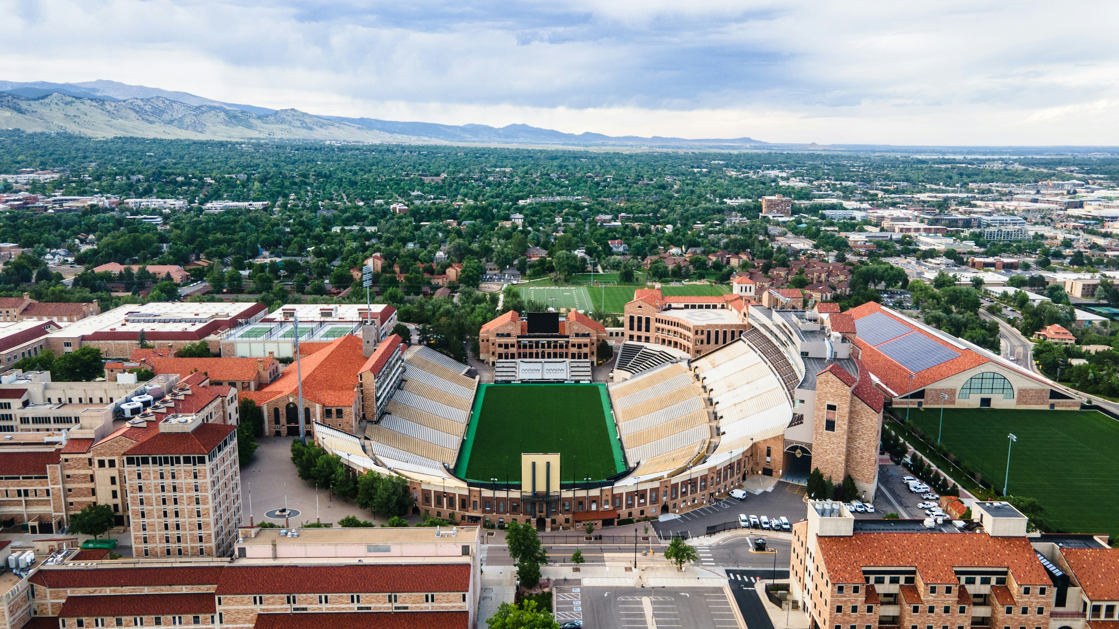 Aerial view of a Colorado city with mountains in the background