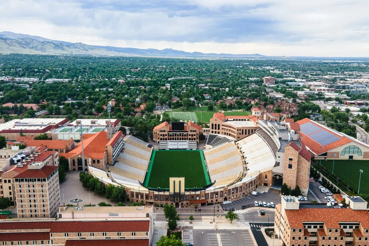 Aerial view of a Colorado city with mountains in the background