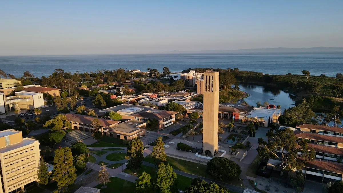 Aerial view of a coastal city with a clock tower near the ocean