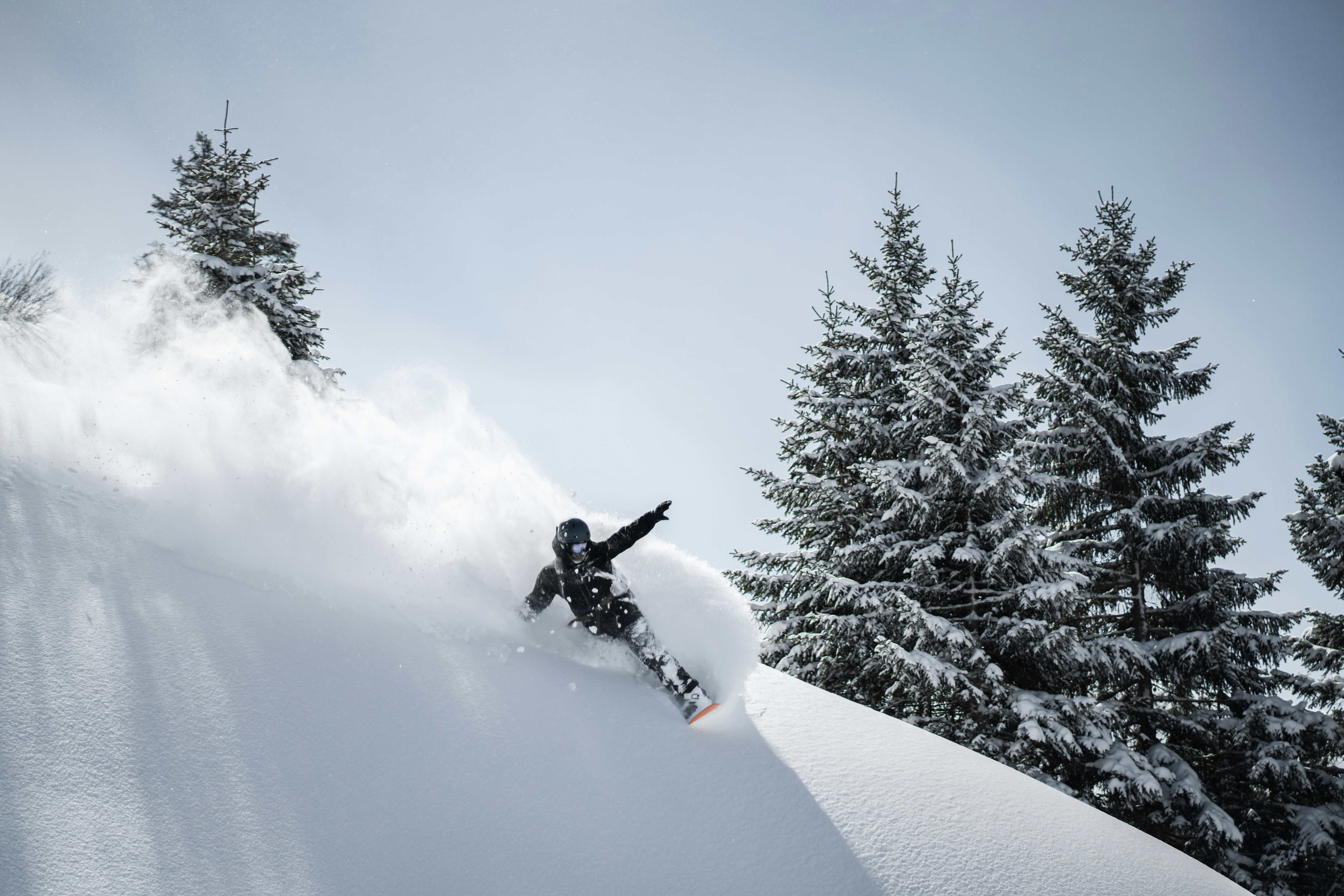 Snowboarder descending a snow-covered mountain slope