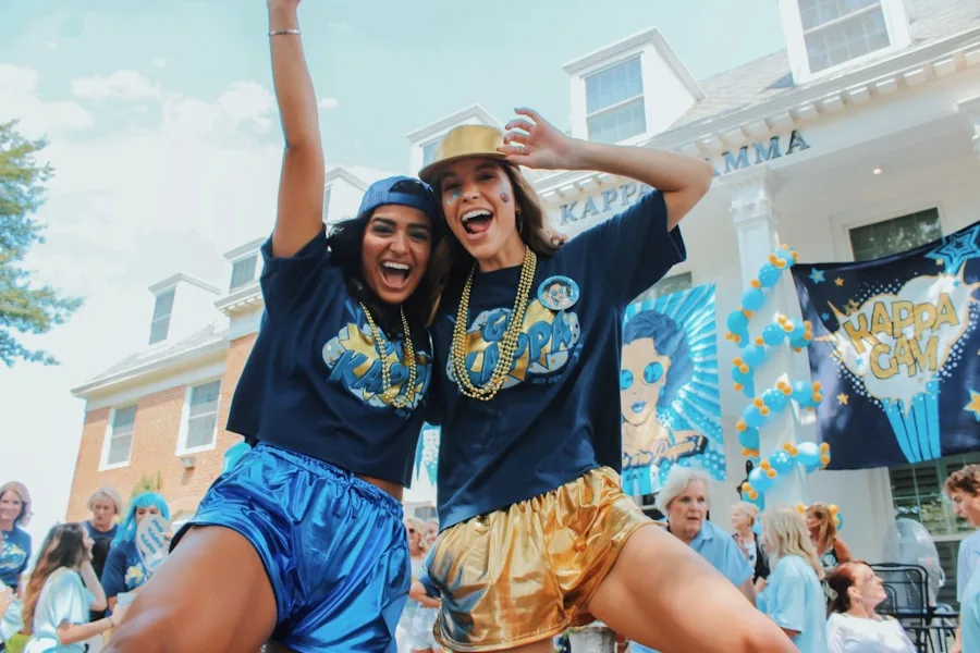 Women wearing matching black shirts and blue and gold shorts at a sorority event
